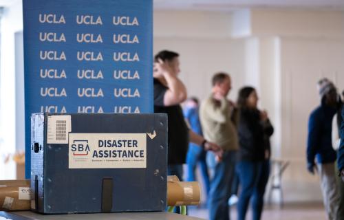 UCLA banner and disaster assistance box with support staff in background