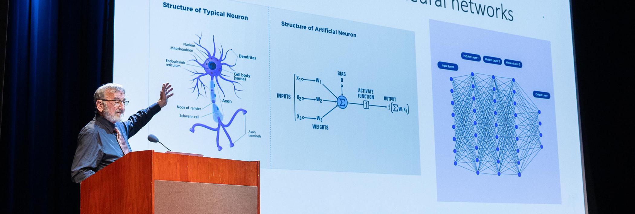 Keith Holyoak presenting slide 2 showcasing a neuron versus an artificial neuron